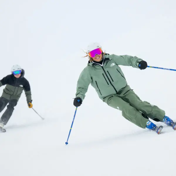Skiers navigating a snowy slope.