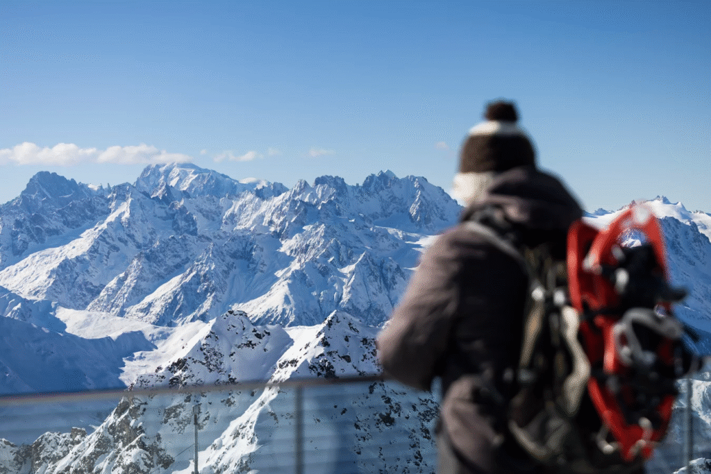 snowshoeing, person wearing brown and white hat looking at the mountain