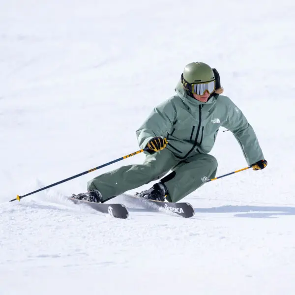 A Ski Instructor Doing A Right Footed Carving Turn