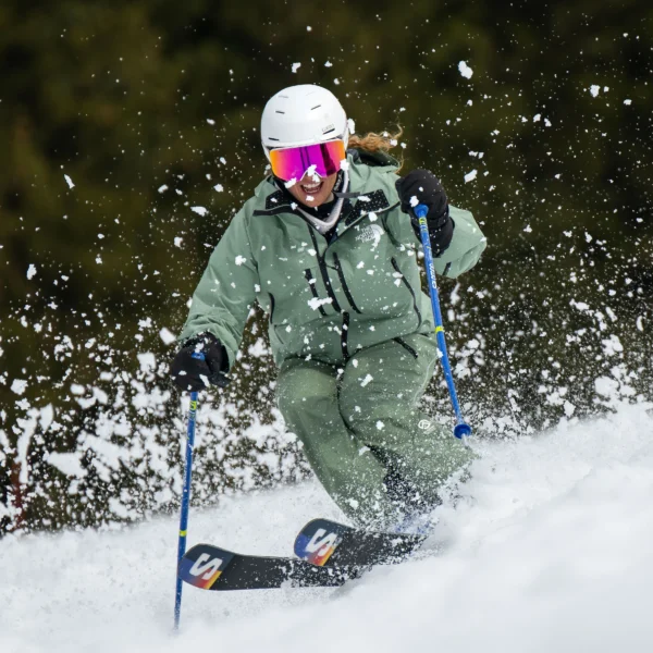 A New Generation Ski Instructor Getting Sprayed By Snow Whilst Skiing Bumps