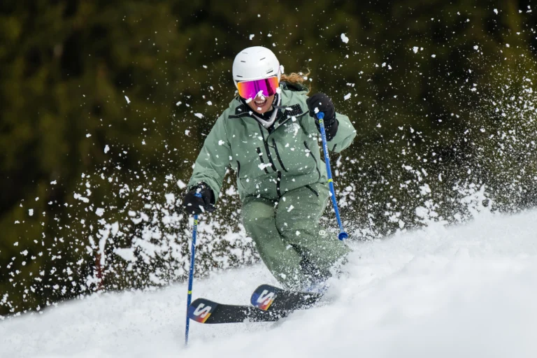 A New Generation Ski Instructor Getting Sprayed By Snow Whilst Skiing Bumps