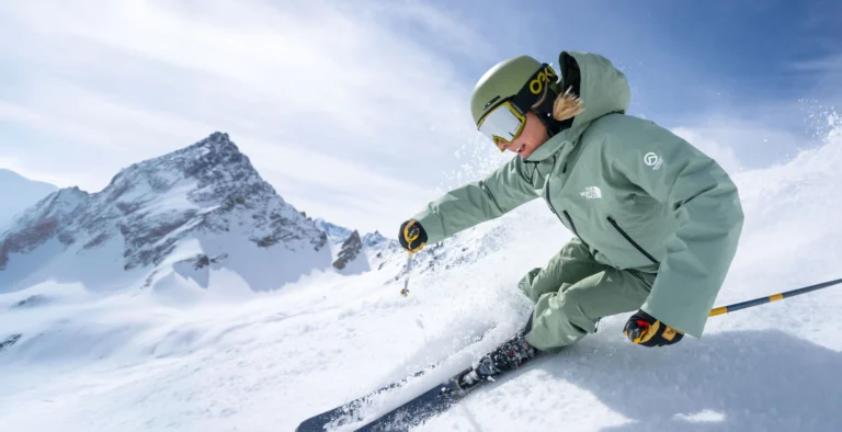 Skier navigating snowy mountain landscape.