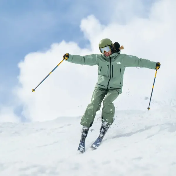 Person skiing on snowy mountain slope.