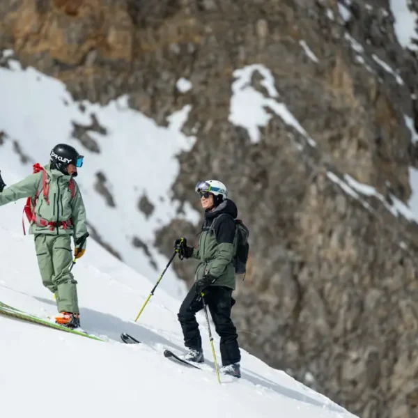 Skiers on a snowy mountain slope.