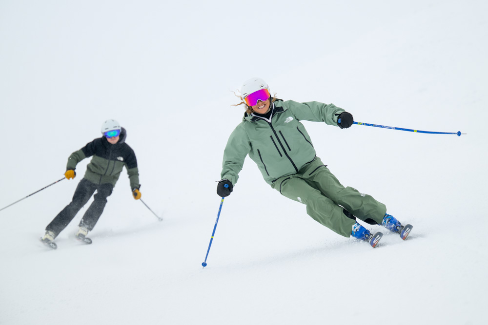 Skiers navigating a snowy slope.