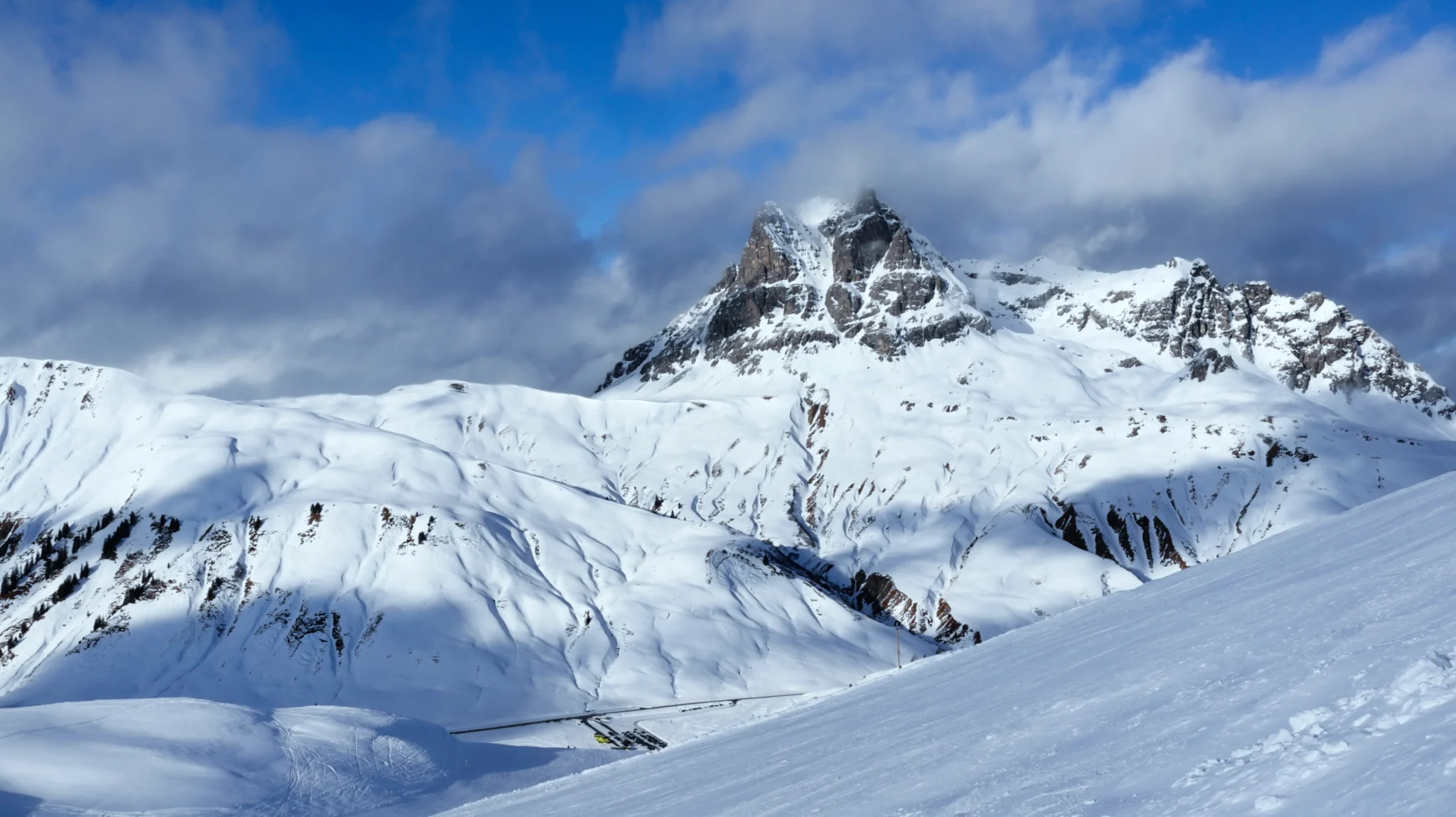 Snowy mountain landscape under blue sky
