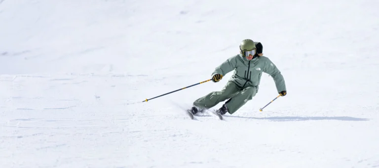 Skier carving through fresh snow.