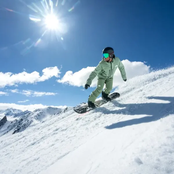 Snowboarder carving through fresh powder.