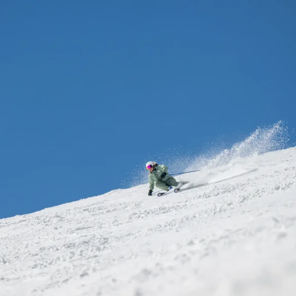 Skier carving through fresh snow