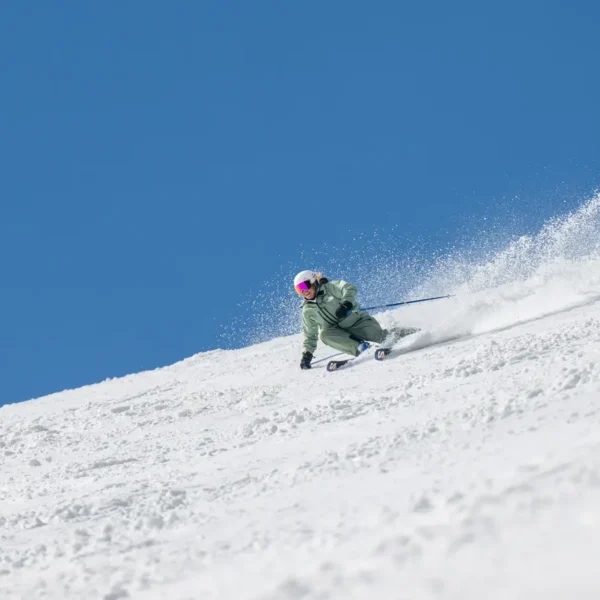 Skier carving through fresh snow
