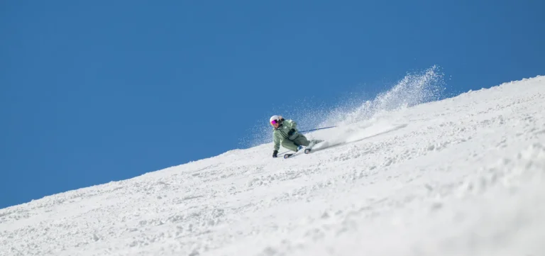 Skier carving through fresh snow