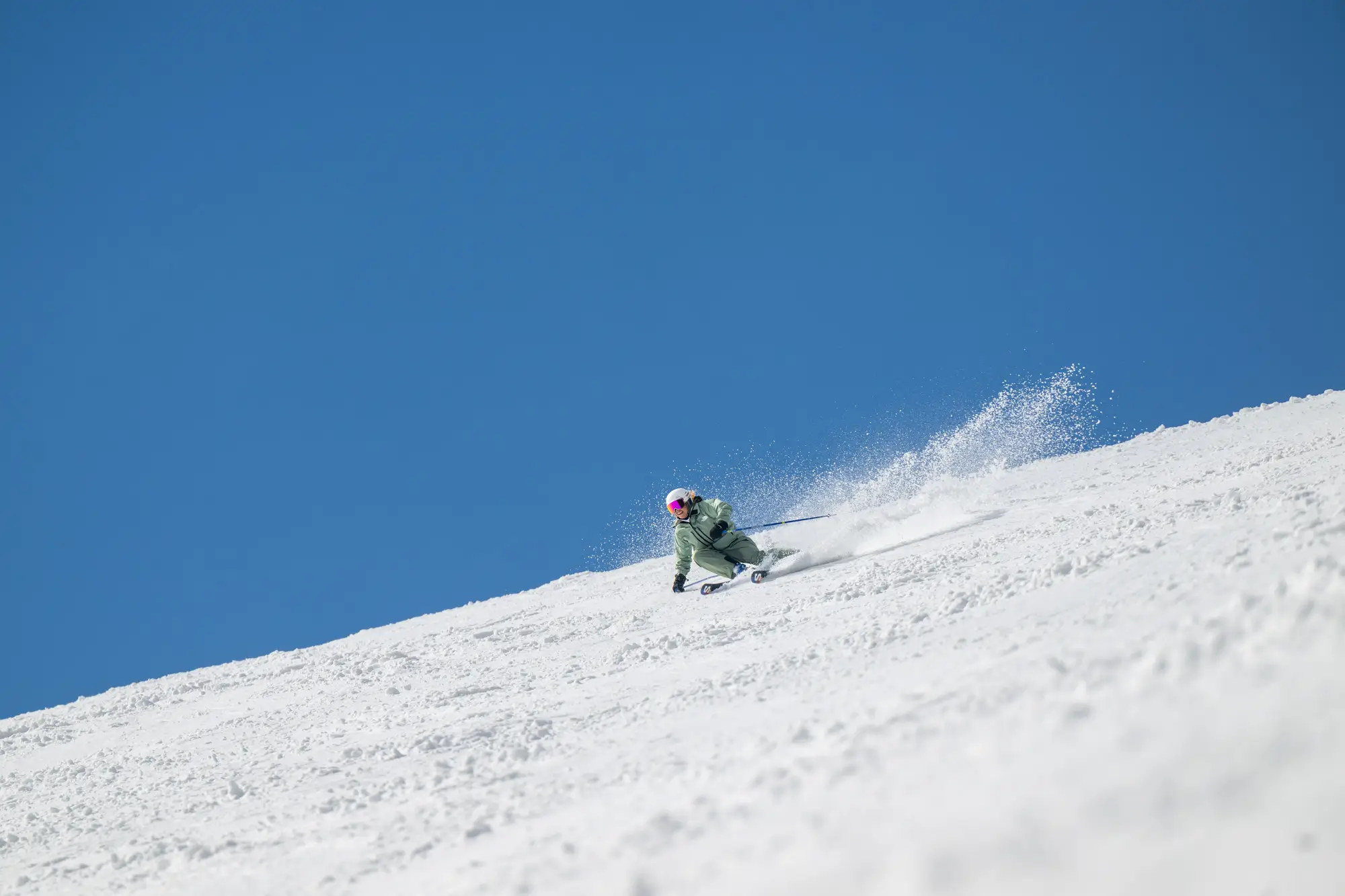 Skier carving through fresh snow