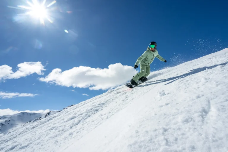 Snowboarder carving through fresh snow.