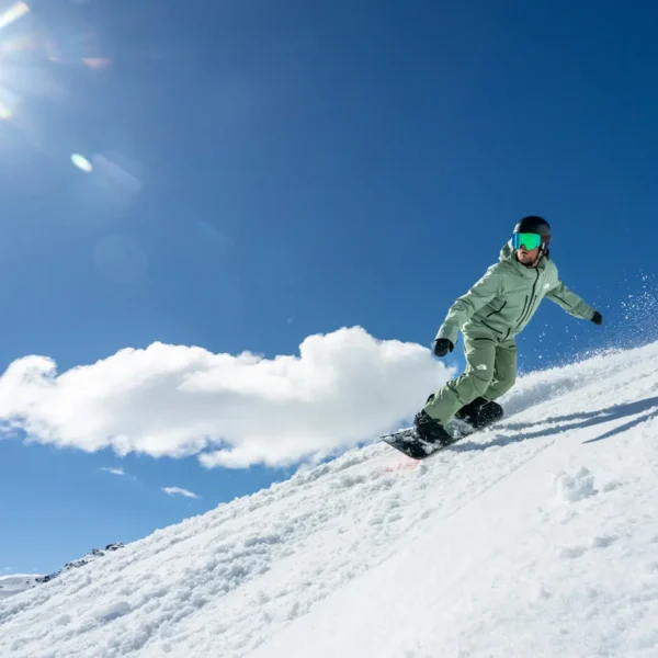 Snowboarder carving through fresh snow.