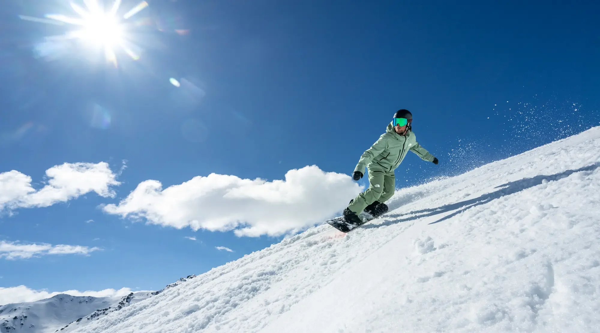 Snowboarder carving through fresh snow.