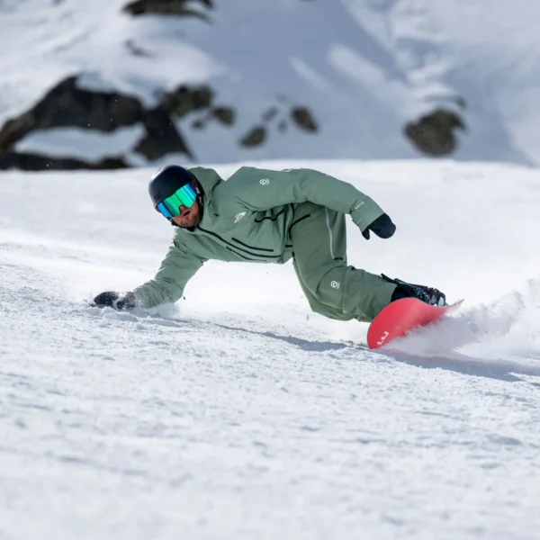 Snowboarder carving through fresh snow.