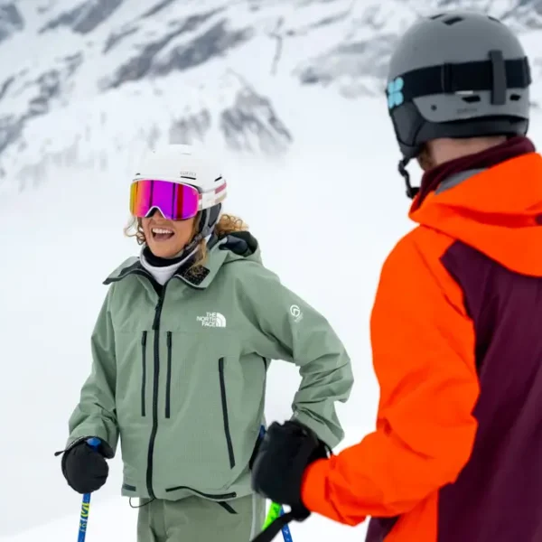 Skiers on snowy mountain landscape.