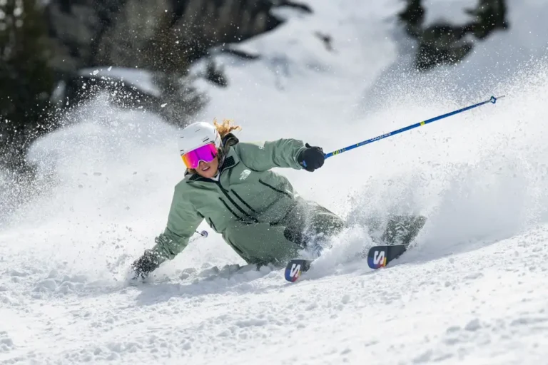 Skier carving through fresh snow.