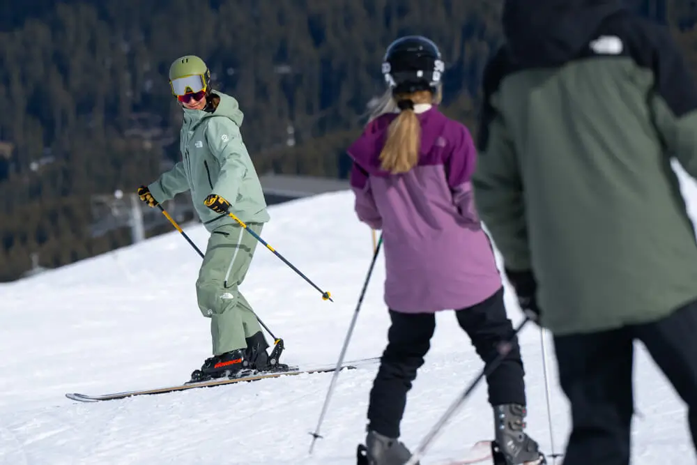 Skiers practicing on snowy slope.