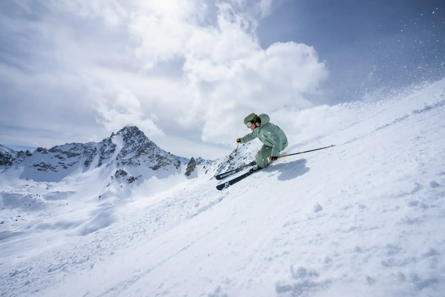 new generation ski instructor skiing in green uniform