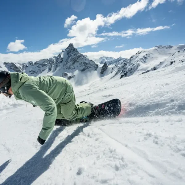 Snowboarder carving through fresh powder