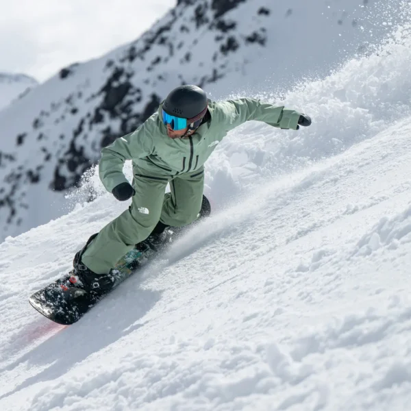 Snowboarder carving through fresh powder