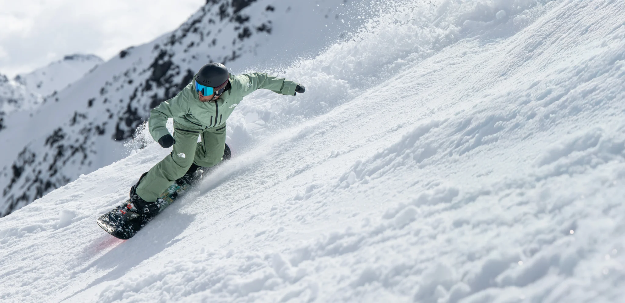 Snowboarder carving through fresh powder