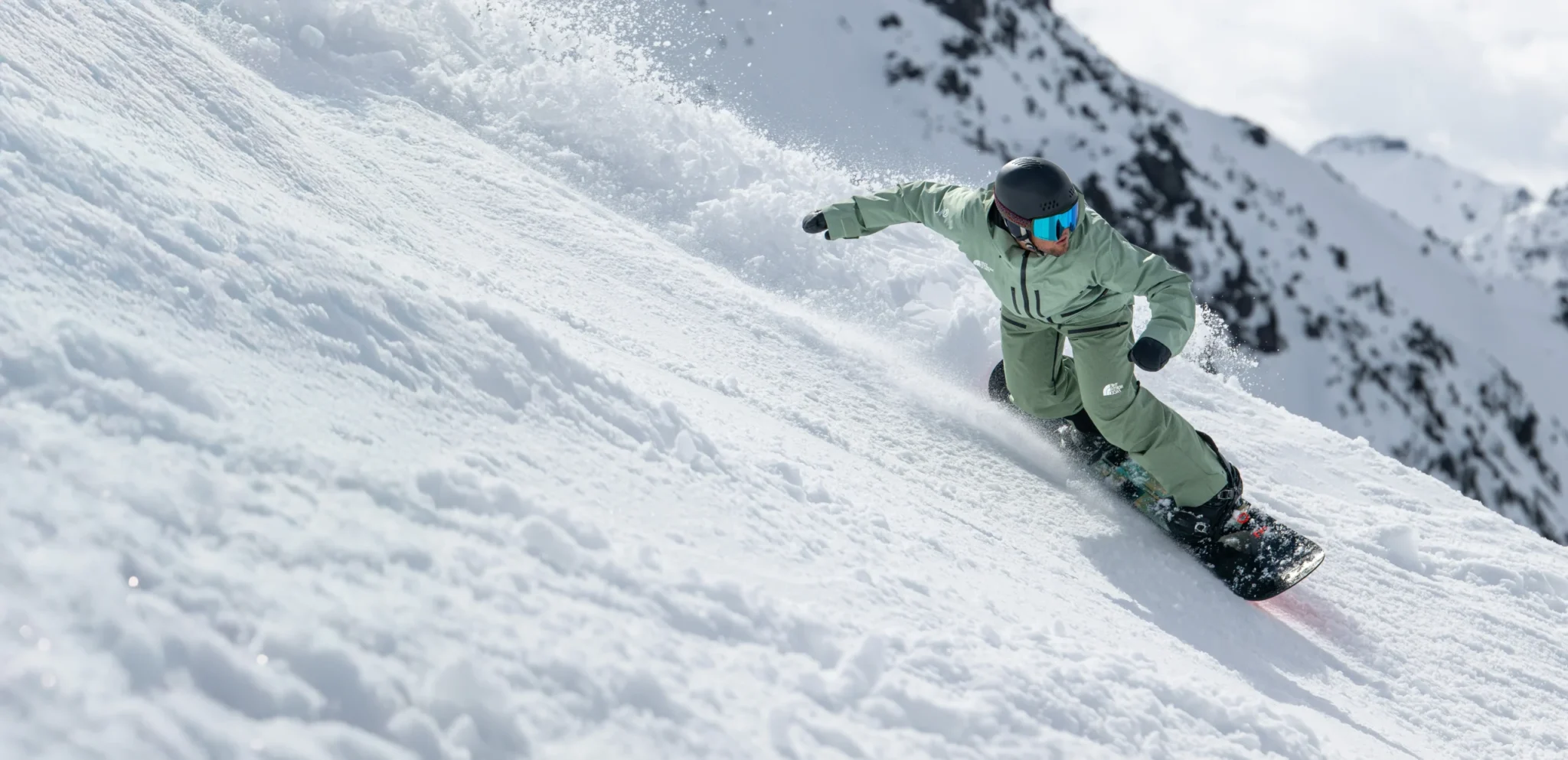 Snowboarder carving through fresh powder