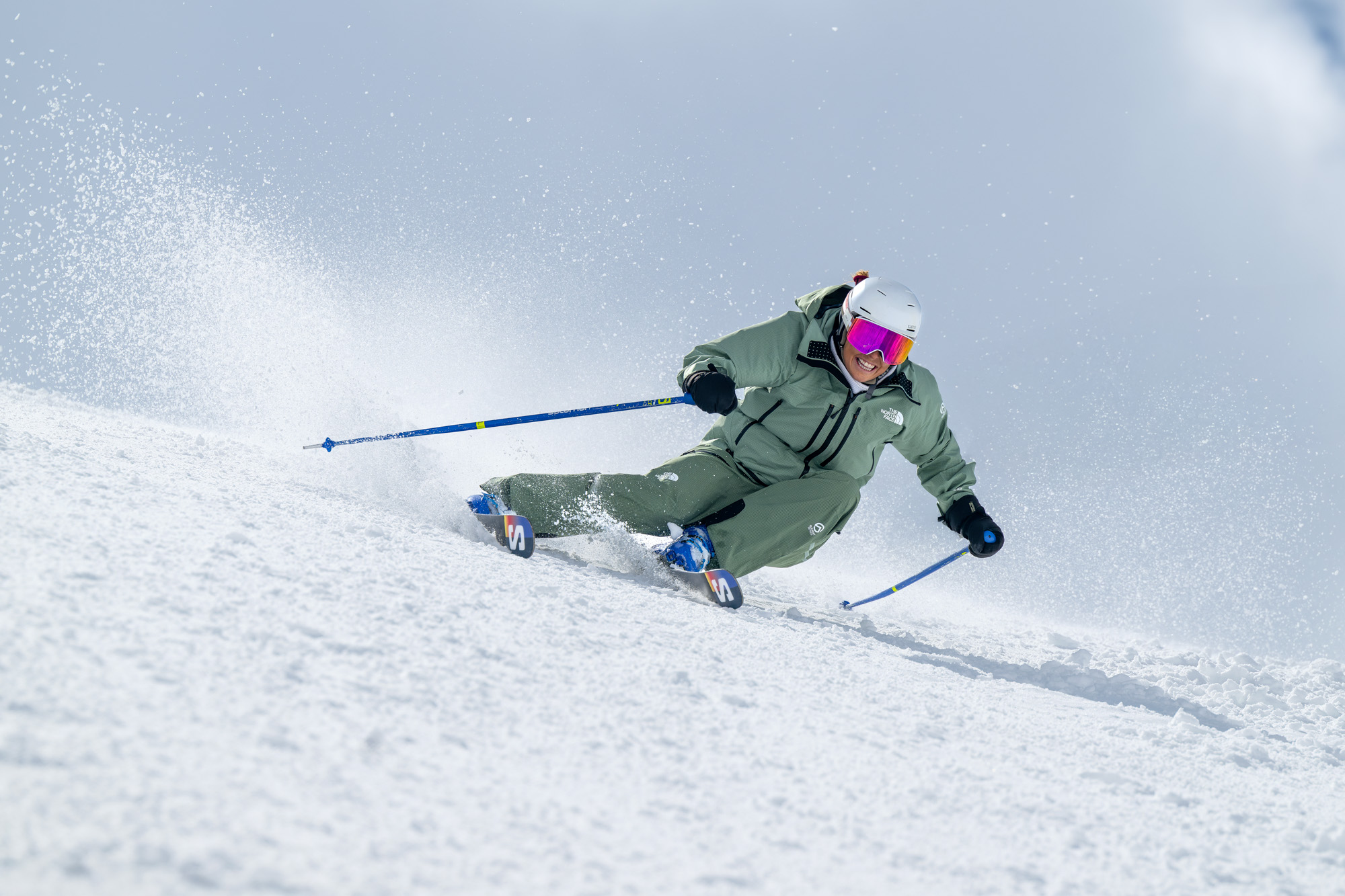 Skier carving through fresh snow.