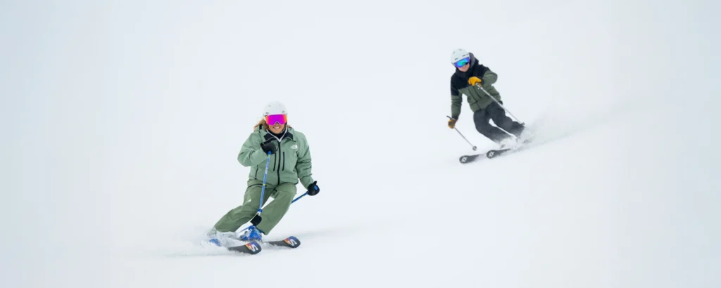 A New Generation Ski Instructor And A Trainee Skiing Basi Level 2 Steeps