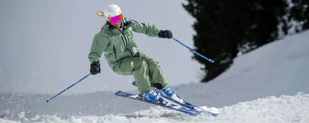 A New Generation ski instructor getting air whilst skiing on a BASI Level 2 bumps pitch