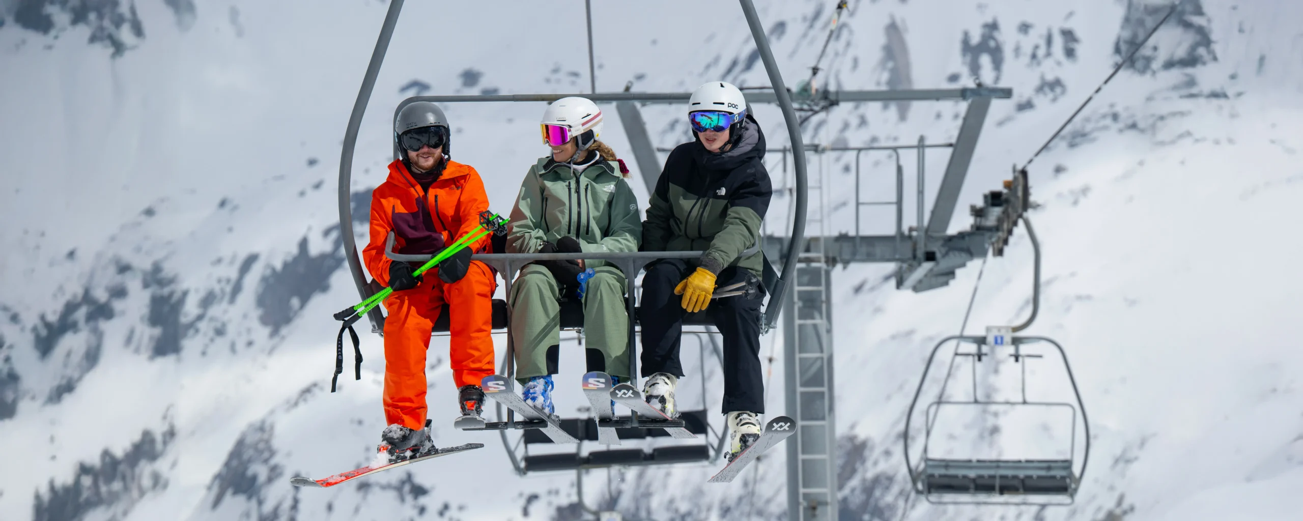 A New Generation Ski Instructor On A Chairlift With Guests