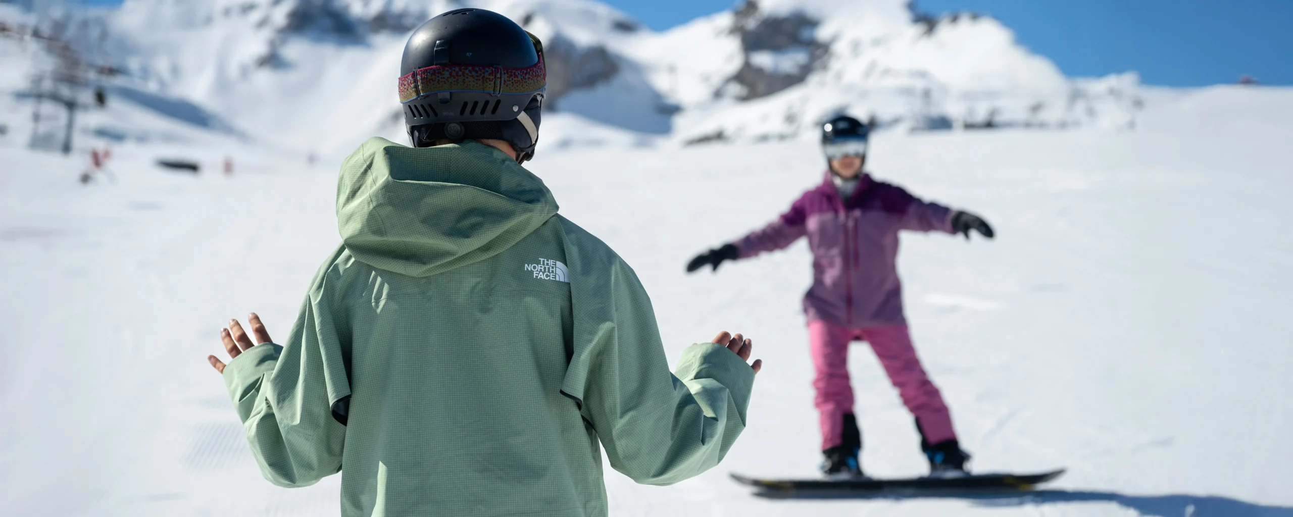A New Generation Snowboard Instructor Giving A Feedback To A Beginner