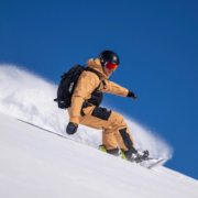 A snowboard instructor making a turn off-piste