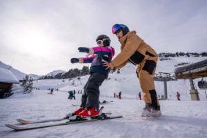 A child learning to ski during a ski lesson in Avoriaz
