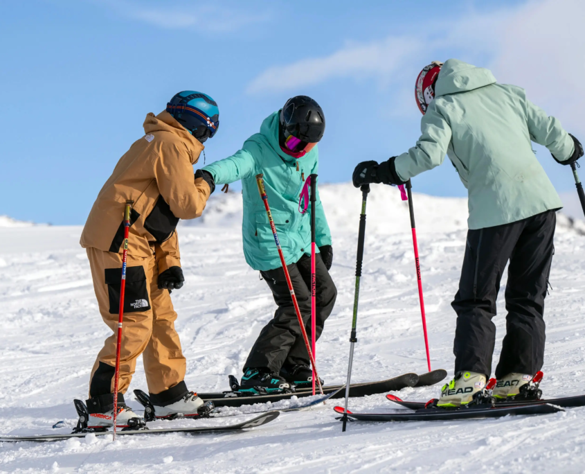 A ski instructor delivering technical feedback