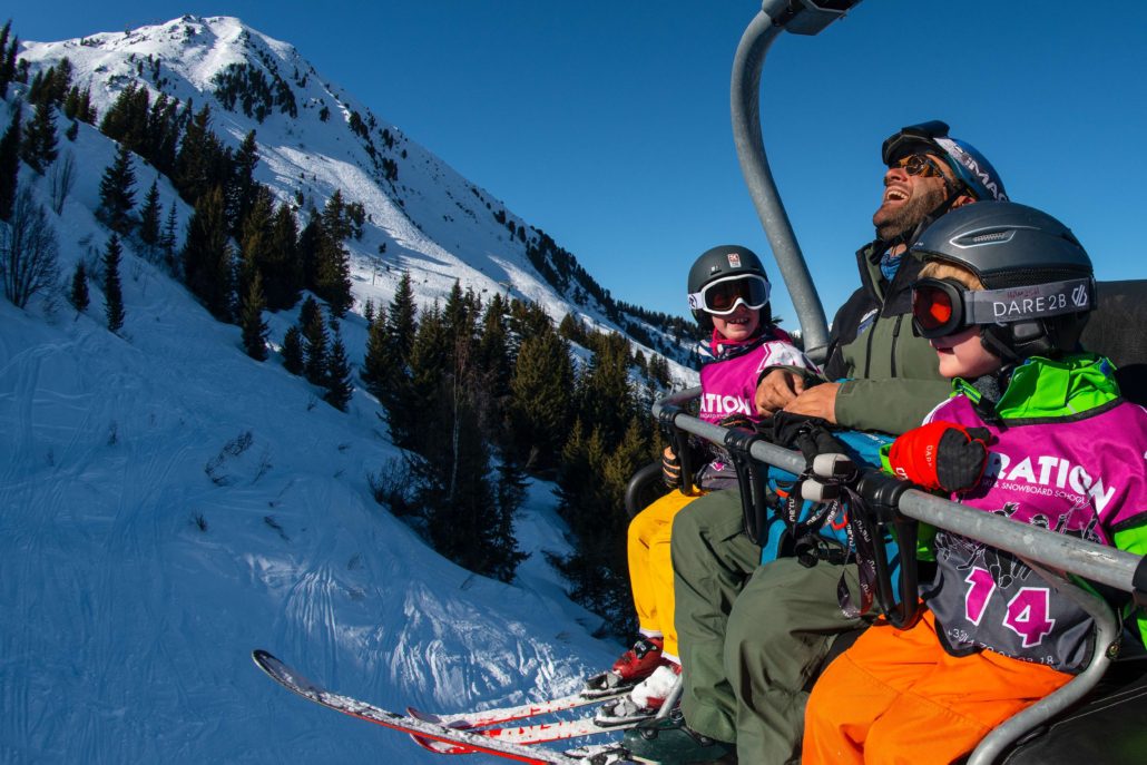 Kids on a chairlift with ski instructor