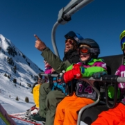 CHildren on a chairlift with a ski instructor