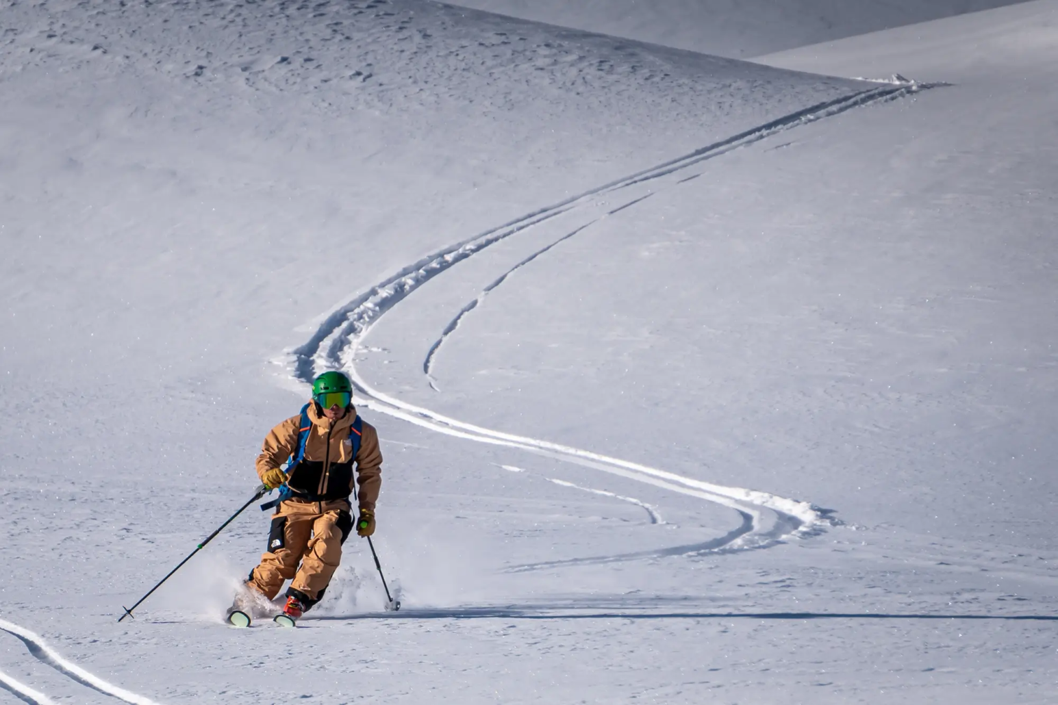 Skier making turns on untouched snow