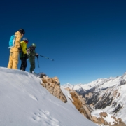 A ski instructor showing pupils the terrain they will be skiing