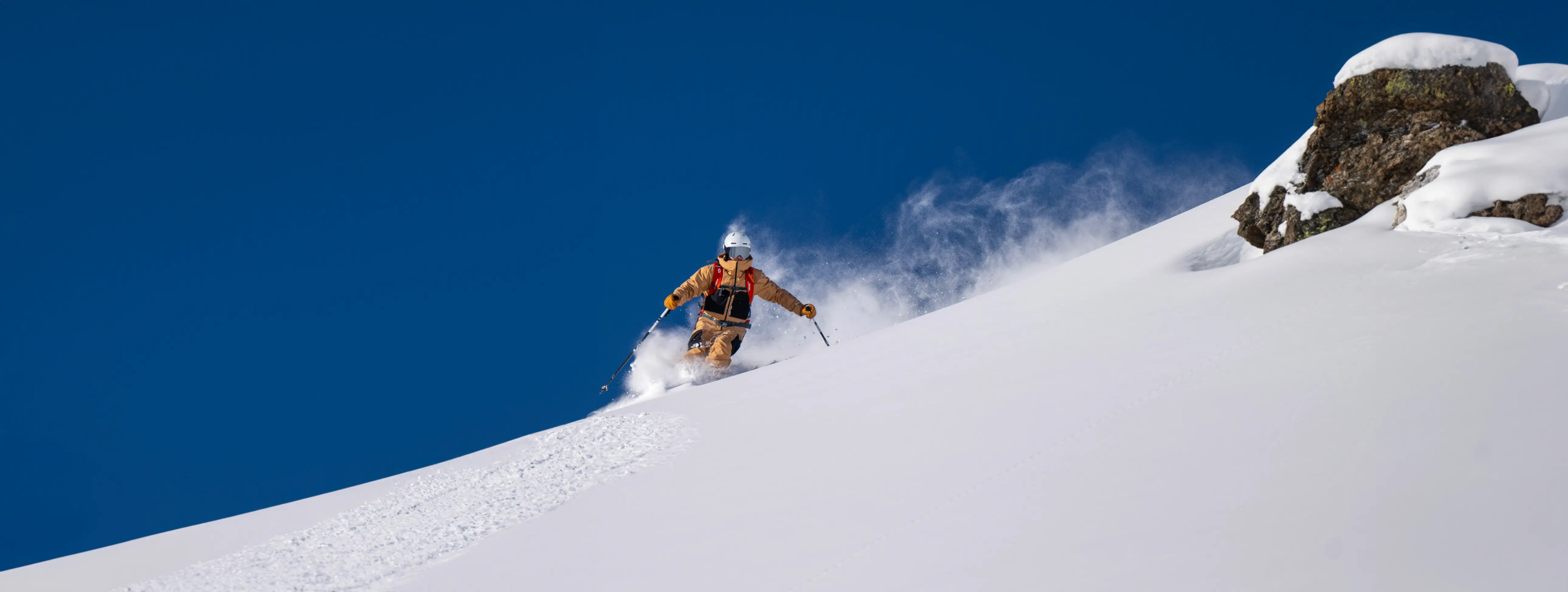 A ski instructor skiing powder in Val Thorens
