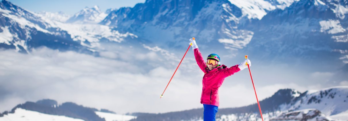 Young active woman skiing in the mountains.
