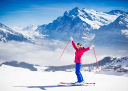 Young active woman skiing in the mountains.