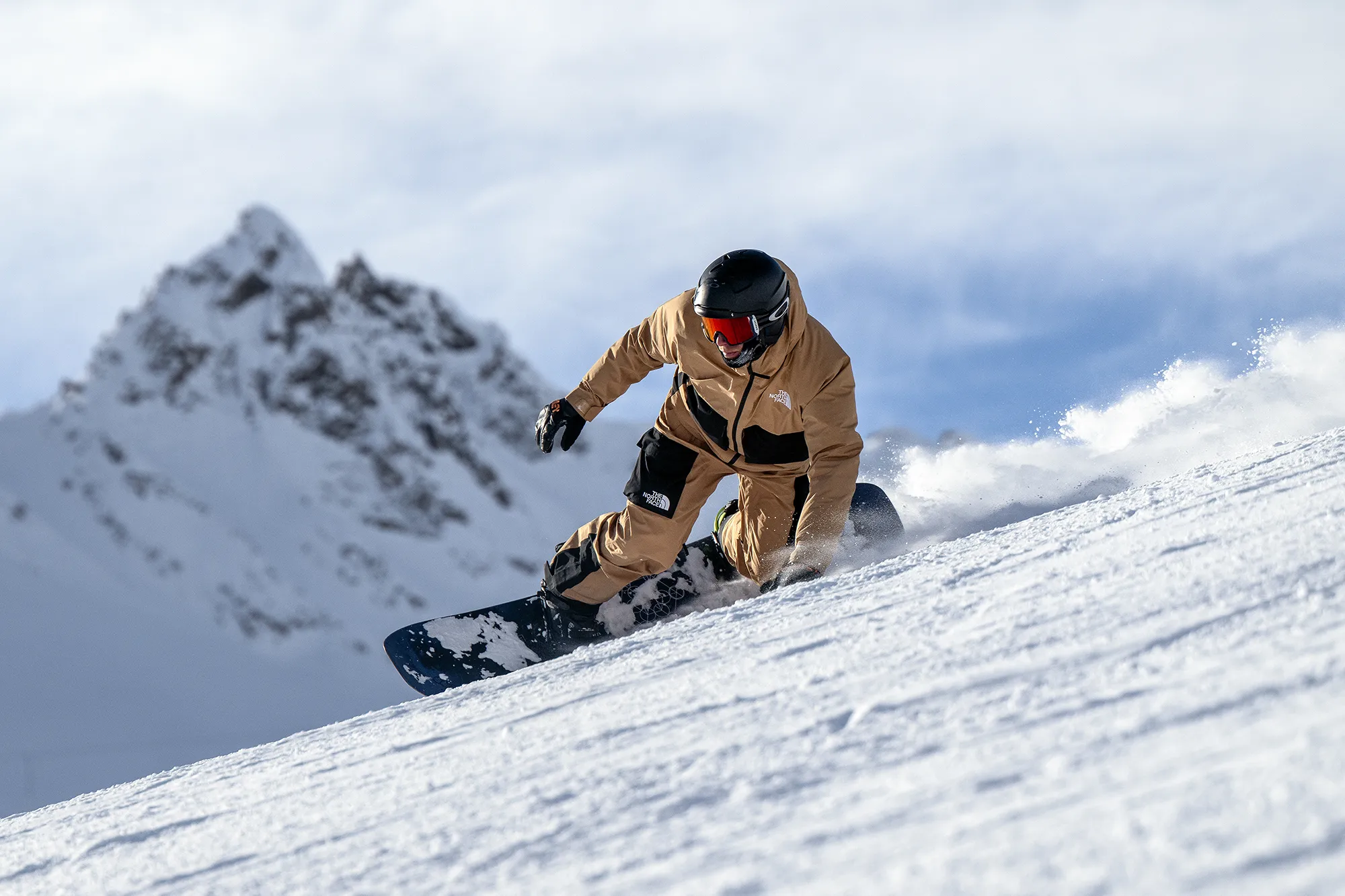 A Snowboarder making a carved turn in a snowboard lesson